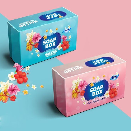 Custom printed blue soap box featuring floral graphics and Halcon Packaging branding displayed on a pink surface.
