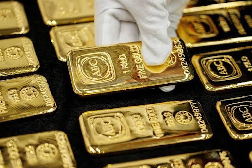 Stacked 24K fine gold bullion bars displaying weight and purity stamps