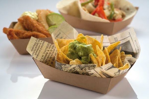 Kraft paper food tray boxes filled with nachos, guacamole, and fried chicken strips
